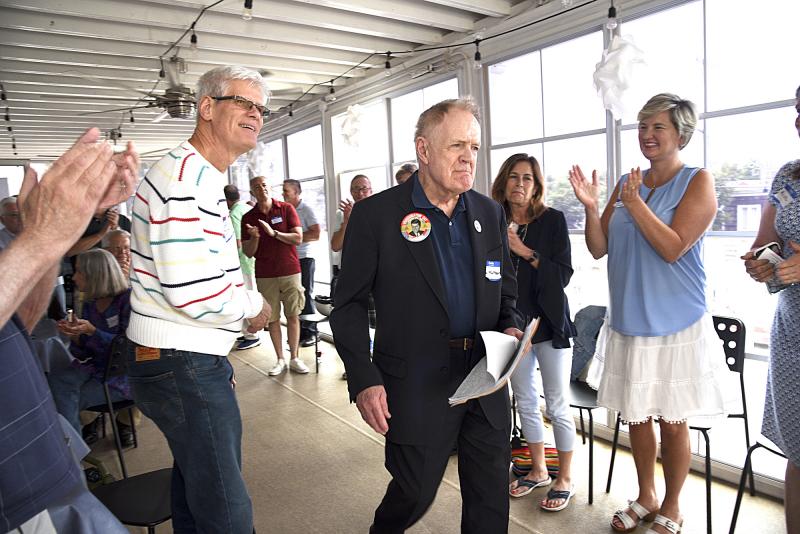 Paul Kuntzler receives a standing ovation as he takes the stage to reflect on his early activism.